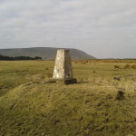 Stang Top Moor trig point with Pendle Hill in the background.